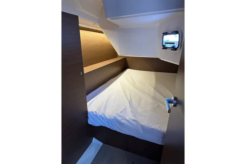 Claire Elise Yacht Photos Pics 2024 Beneteau Oceanis 37.1 cabin interior with bed and porthole window.