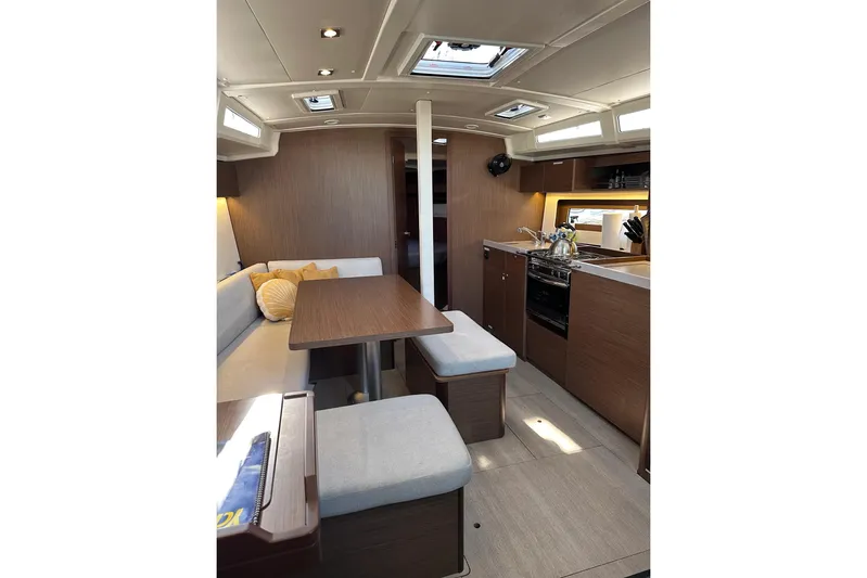 Claire Elise Yacht Photos Pics Interior of 2024 Beneteau Oceanis 37.1 yacht, featuring modern kitchen and cozy seating area.