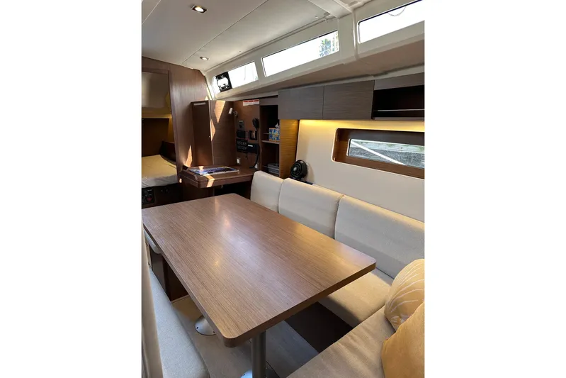 Claire Elise Yacht Photos Pics Interior of 2024 Beneteau Oceanis 37.1 yacht, featuring a modern dining area with wood finishes.
