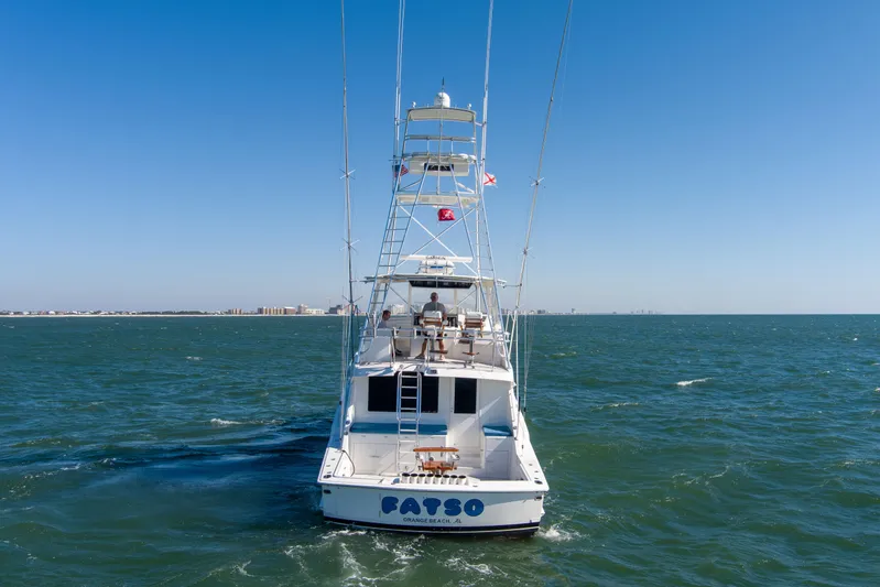 Fatso Yacht Photos Pics 1998 Hatteras 60 Convertible yacht cruising on open water under clear blue sky.