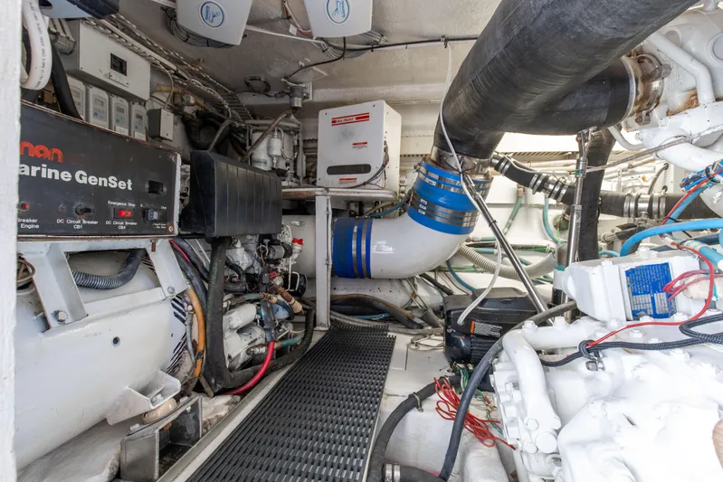 Fatso Yacht Photos Pics Engine room of 1998 Hatteras 60 Convertible yacht, featuring marine generator and piping.