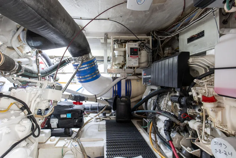 Fatso Yacht Photos Pics Engine room of 1998 Hatteras 60 Convertible yacht, showcasing mechanical components and wiring.