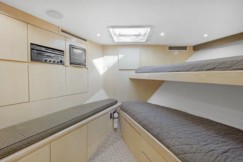 Fatso Yacht Photos Pics Interior cabin of 1998 Hatteras 60 Convertible yacht with bunk beds and storage.