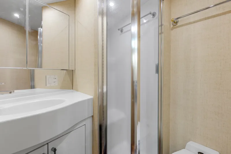 Fatso Yacht Photos Pics Bathroom interior of 1998 Hatteras 60 Convertible yacht with shower and vanity.