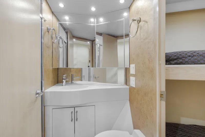 Fatso Yacht Photos Pics Luxurious bathroom in 1998 Hatteras 60 Convertible yacht with modern fixtures and ample lighting.