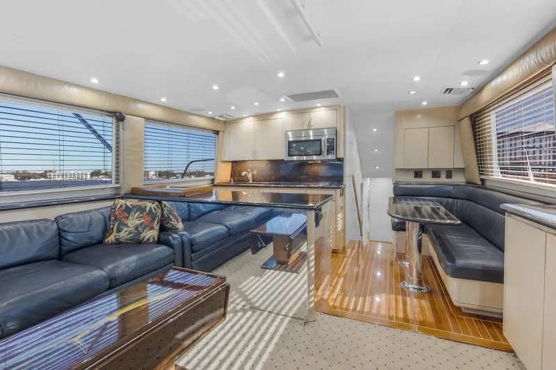 Fatso Yacht Photos Pics Luxurious interior of 1998 Hatteras 60 Convertible yacht with modern kitchen and seating area.