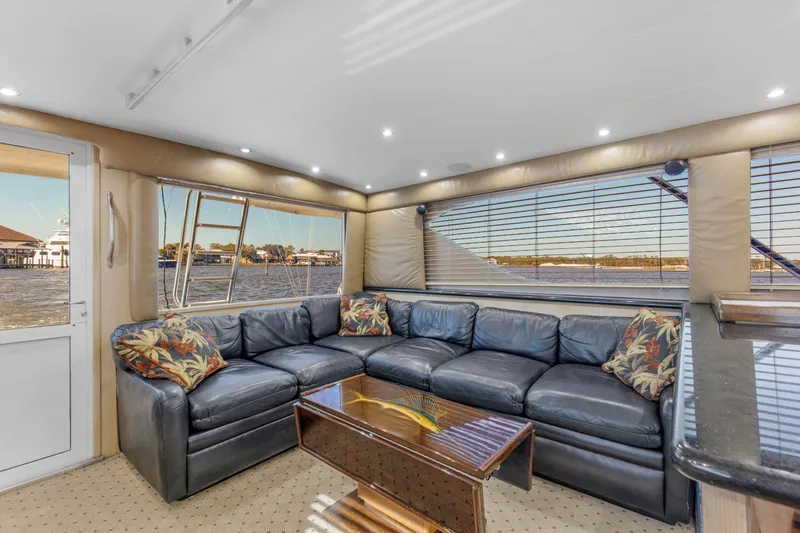 Fatso Yacht Photos Pics Luxurious interior of 1998 Hatteras 60 Convertible yacht with leather seating and scenic views.