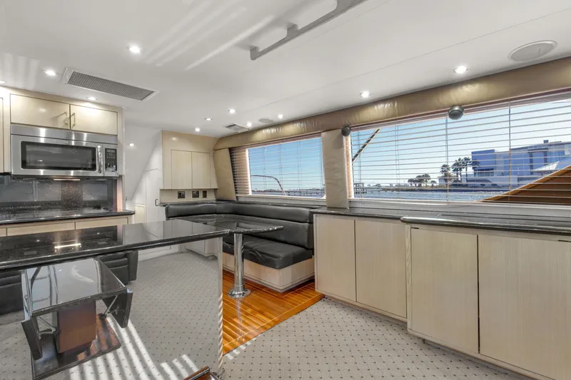 Fatso Yacht Photos Pics Interior of 1998 Hatteras 60 Convertible yacht with modern kitchen and seating area.