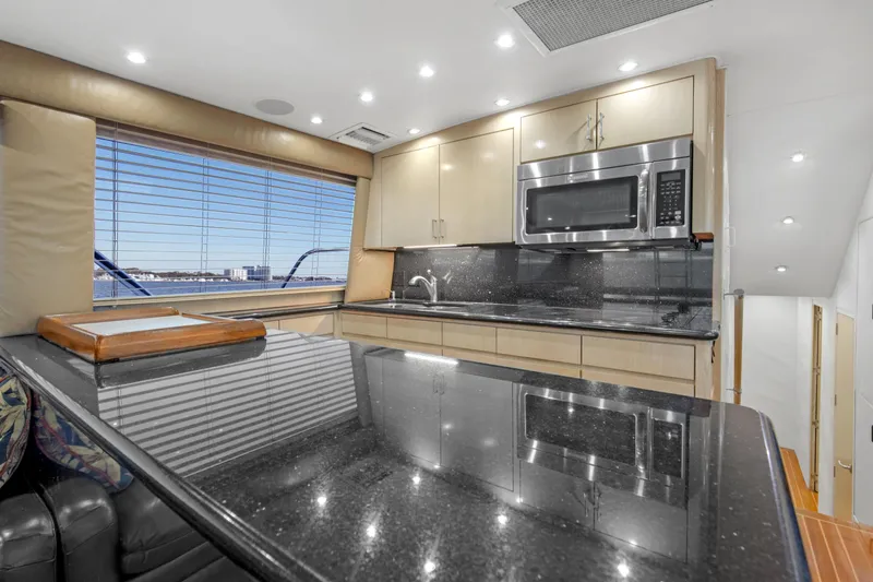 Fatso Yacht Photos Pics Luxurious kitchen interior of 1998 Hatteras 60 Convertible yacht with modern appliances.