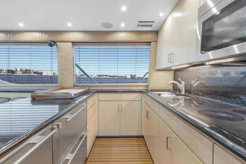 Fatso Yacht Photos Pics Luxurious kitchen interior of 1998 Hatteras 60 Convertible yacht with modern appliances.