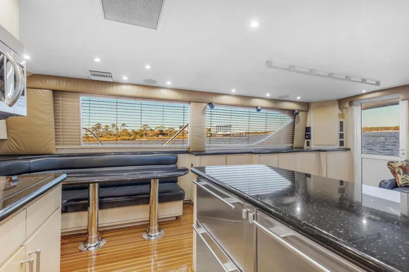 Fatso Yacht Photos Pics Luxurious interior of 1998 Hatteras 60 Convertible yacht with modern kitchen and seating area.