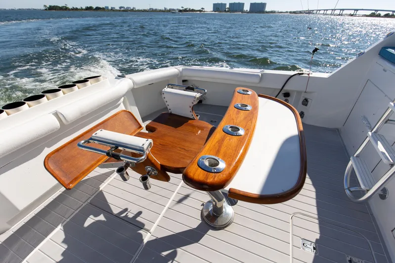 Fatso Yacht Photos Pics 1998 Hatteras 60 Convertible yacht deck with fishing rod holders, ocean view.