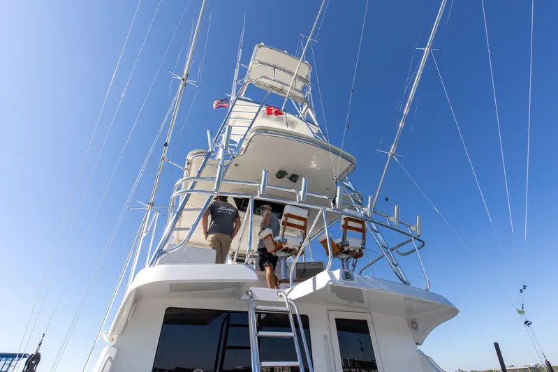 Fatso Yacht Photos Pics 1998 Hatteras 60 Convertible yacht with tower, viewed from below against clear blue sky.