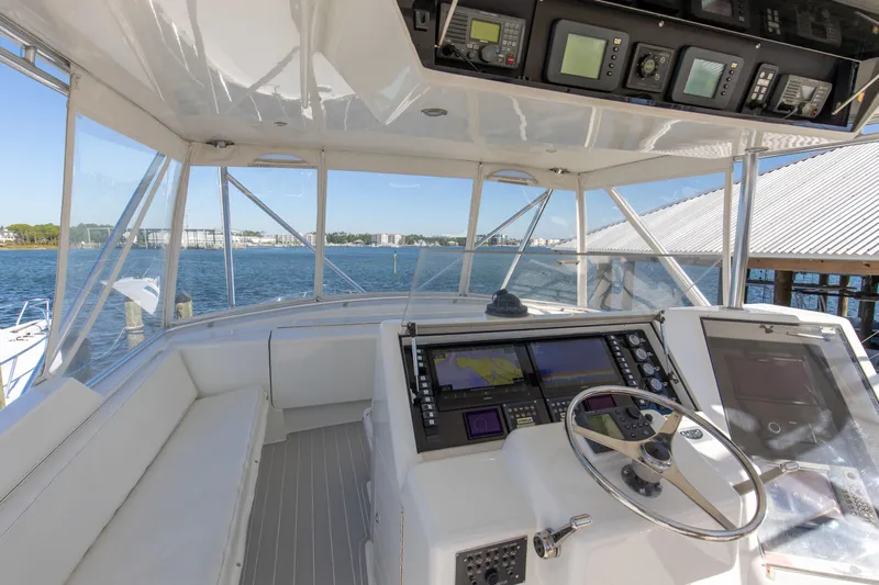 Fatso Yacht Photos Pics Cockpit of 1998 Hatteras 60 Convertible yacht with navigation equipment and ocean view.