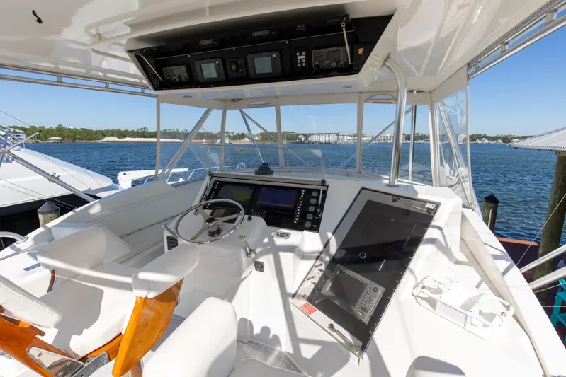 Fatso Yacht Photos Pics 1998 Hatteras 60 Convertible yacht cockpit with steering wheel and navigation equipment.
