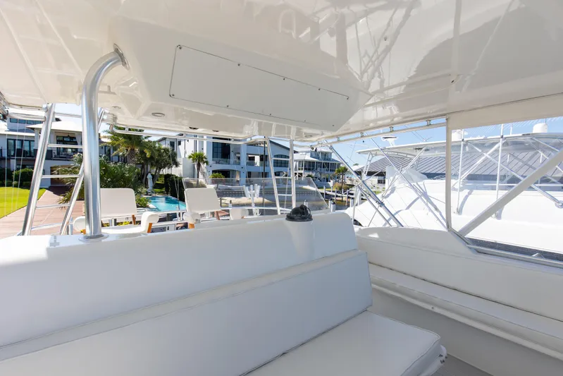 Fatso Yacht Photos Pics 1998 Hatteras 60 Convertible yacht interior with white seating and marina view.