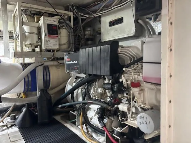 Fatso Yacht Photos Pics Engine room of a 1998 Hatteras 60 Convertible yacht, featuring mechanical components and wiring.