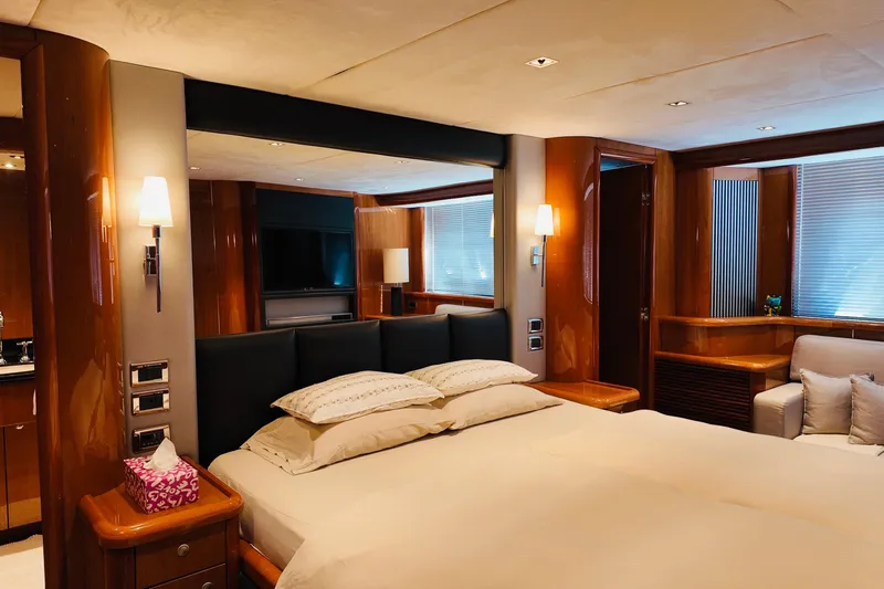 Samba Pa Ti Yacht Photos Pics Luxurious bedroom interior of 2004 Sunseeker 94 Yacht with elegant wood finishes and modern lighting.