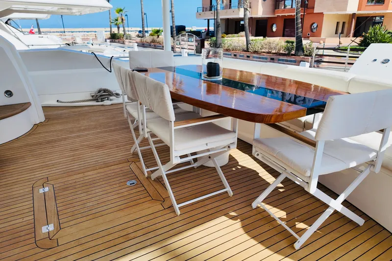 Samba Pa Ti Yacht Photos Pics Luxurious Sunseeker 94 Yacht 2004 deck with elegant dining area and ocean view.