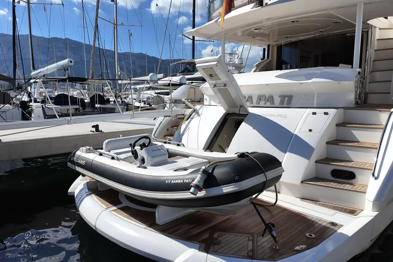 Samba Pa Ti Yacht Photos Pics 2004 Sunseeker 94 Yacht with tender at marina, showcasing luxury and elegance.