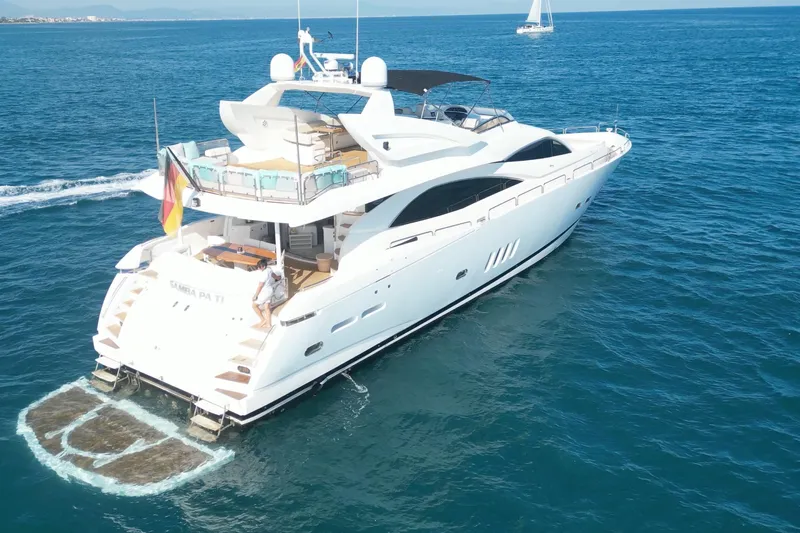 Samba Pa Ti Yacht Photos Pics Luxurious 2004 Sunseeker 94 Yacht cruising on open sea with clear blue waters.