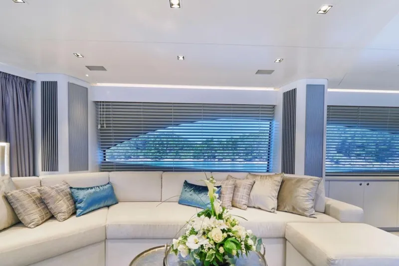 Samba Pa Ti Yacht Photos Pics Luxurious interior of 2004 Sunseeker 94 Yacht with elegant seating and floral centerpiece.