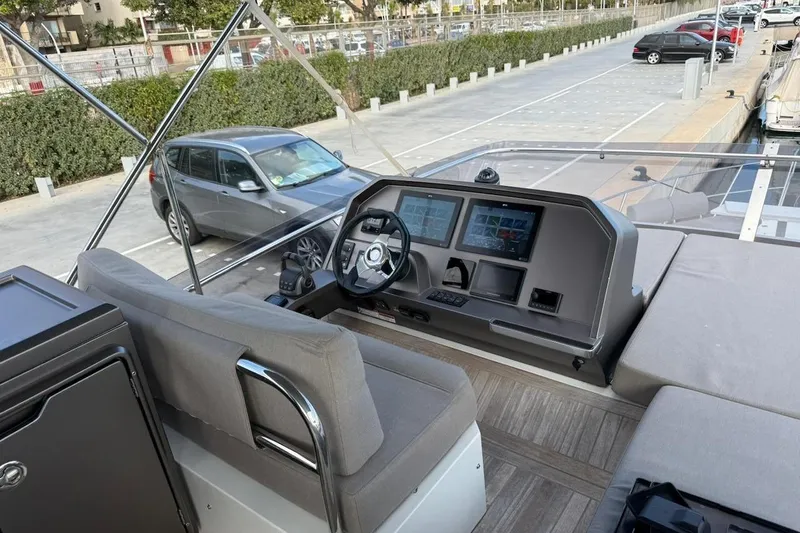  Yacht Photos Pics Flybridge helm of 2023 Galeon 460 Fly yacht with modern controls and seating.