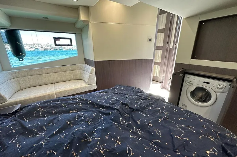  Yacht Photos Pics Luxurious interior of 2023 Galeon 460 Fly yacht with bed, sofa, and washing machine.
