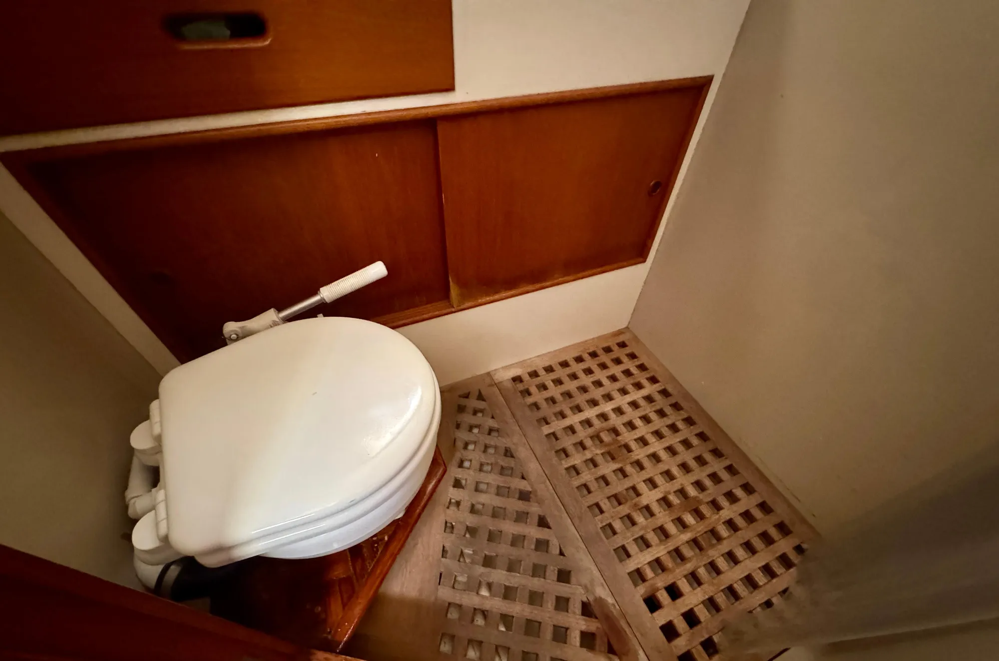 1979 Grand Banks Classic boat bathroom with wooden flooring and compact toilet.
