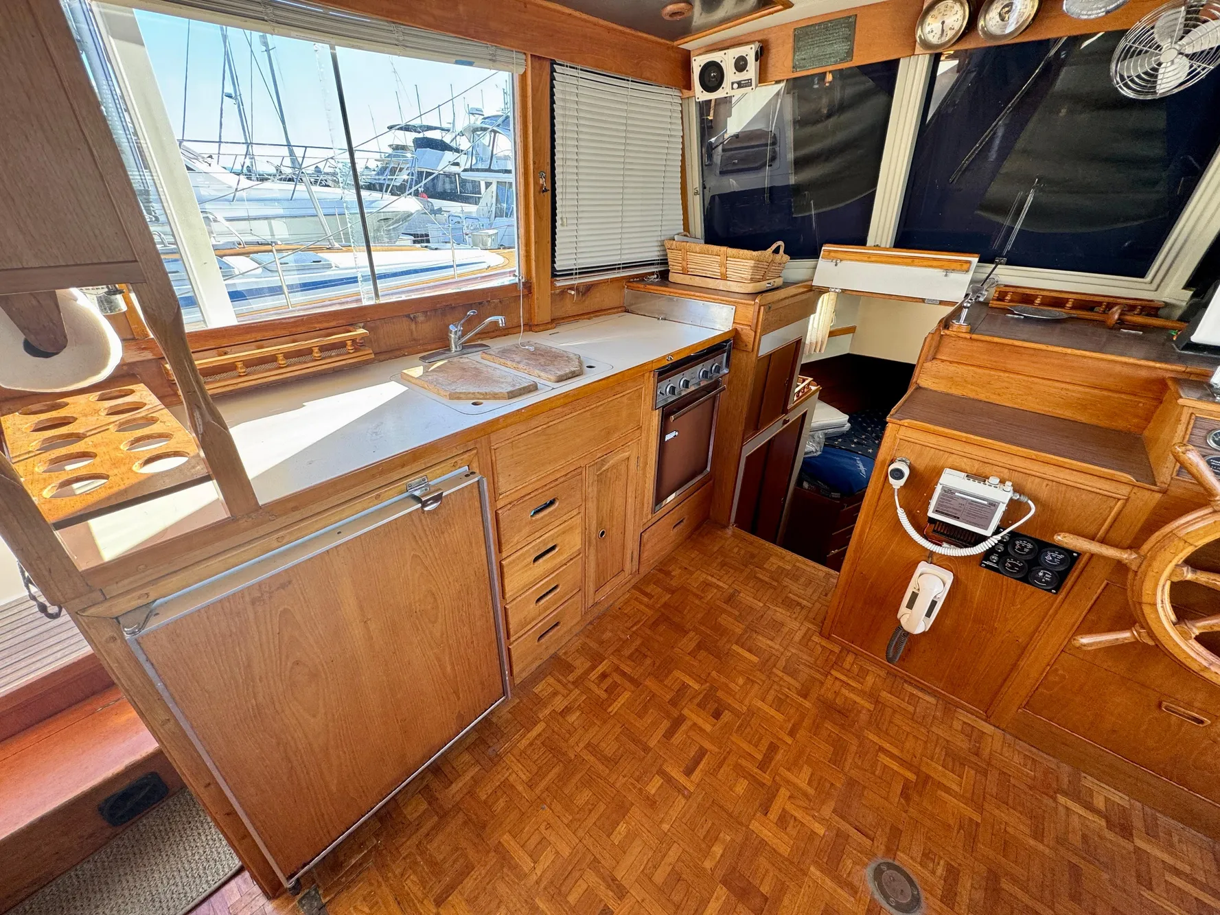 1979 Grand Banks Classic yacht interior with wooden cabinetry and nautical instruments.