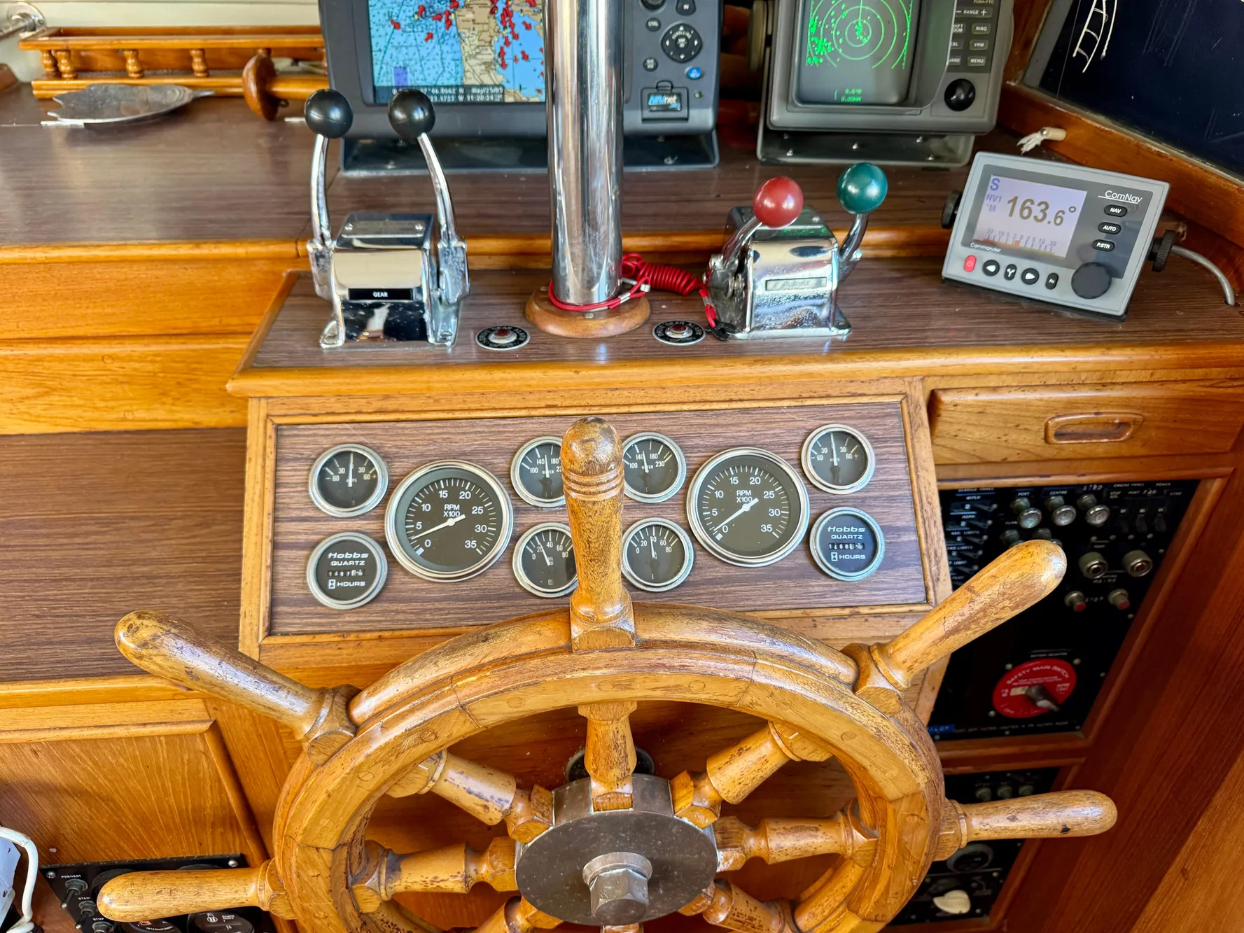 1979 Grand Banks Classic helm with wooden wheel and navigation instruments.