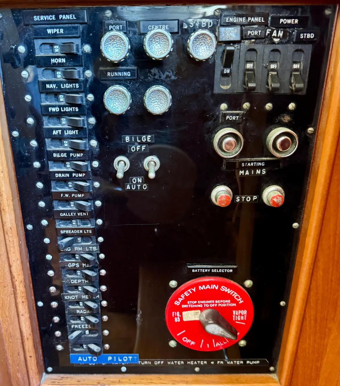 Control panel of a 1979 Grand Banks Classic boat with various switches and indicators.