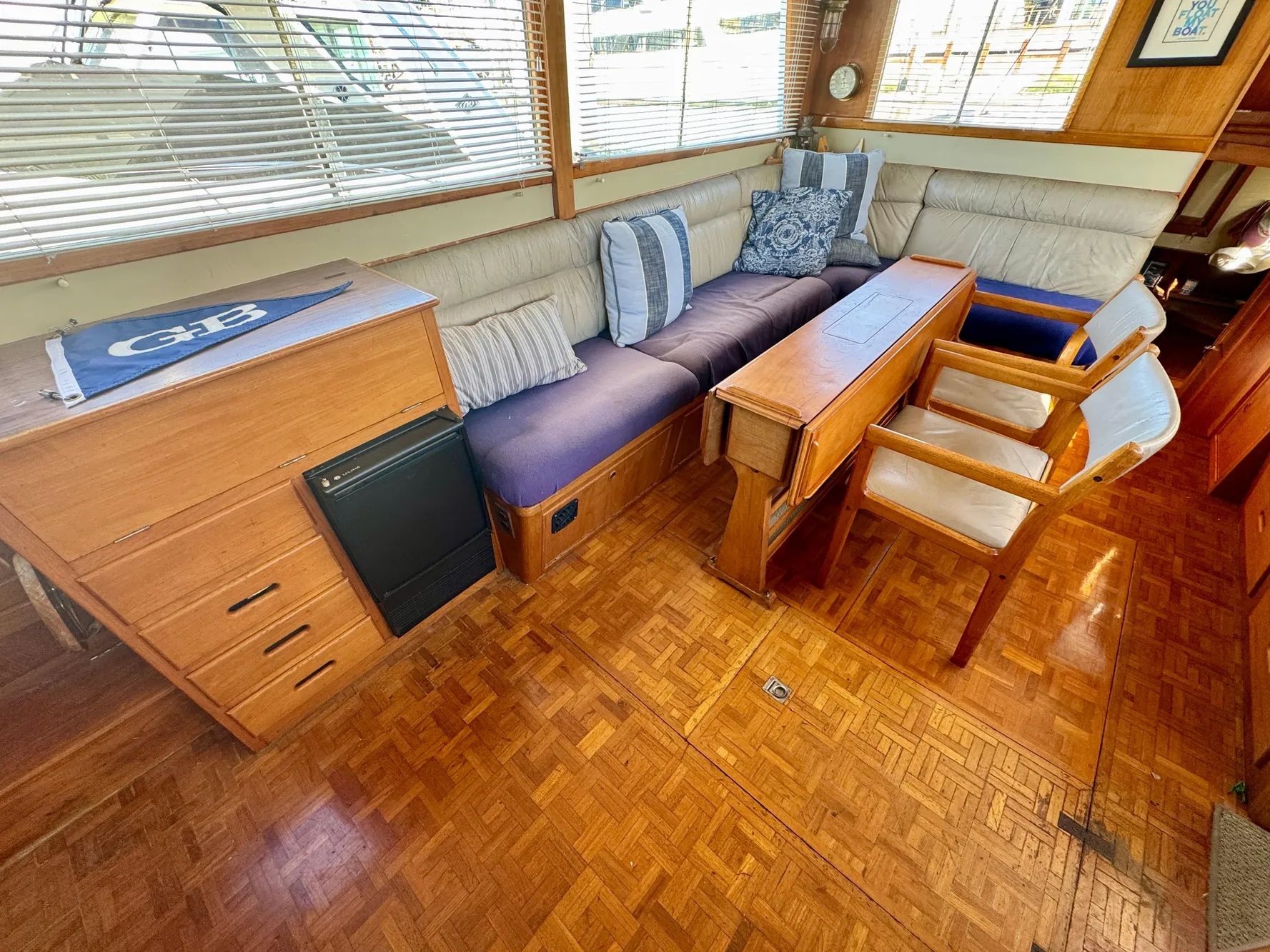 1979 Grand Banks Classic yacht interior with wood flooring and comfortable seating.