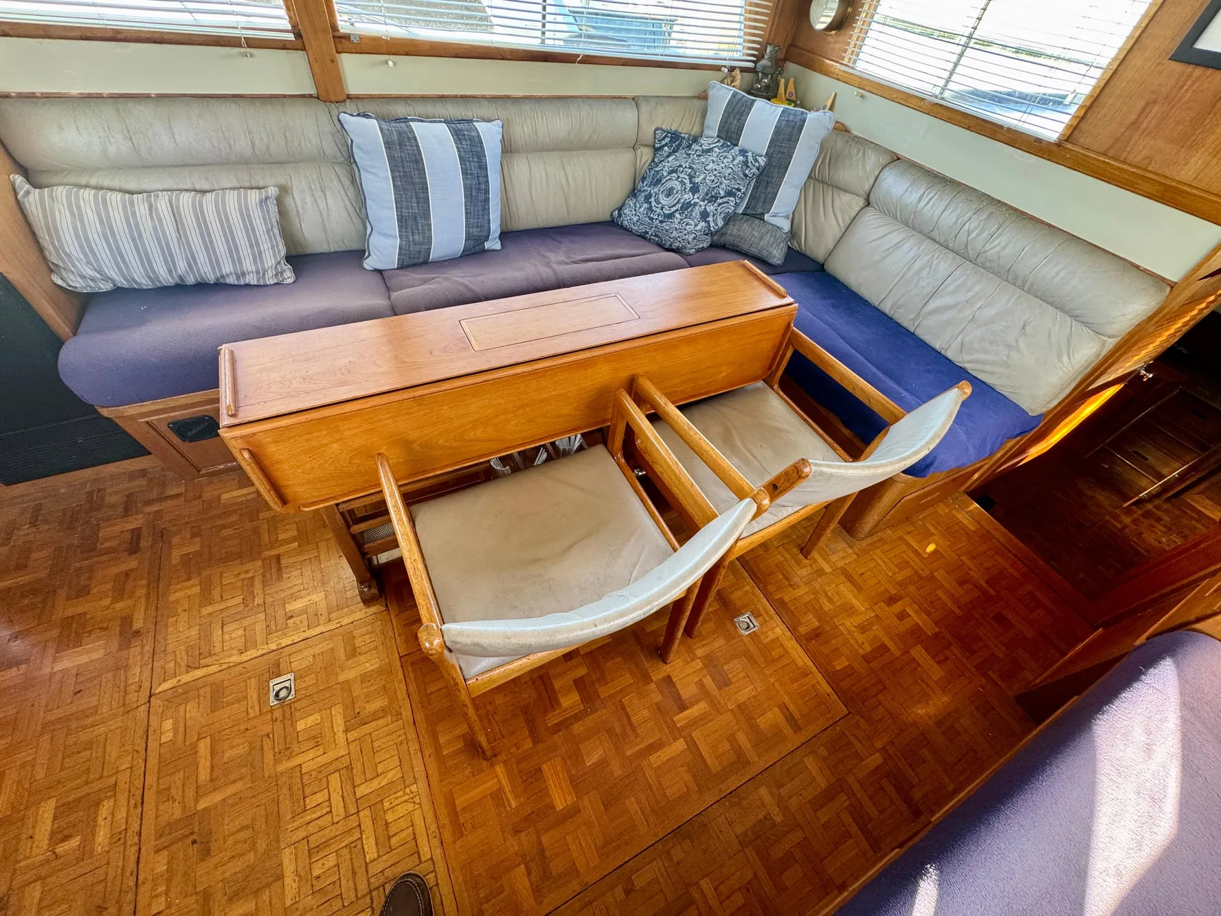 1979 Grand Banks Classic yacht interior with wooden flooring and cozy seating area.