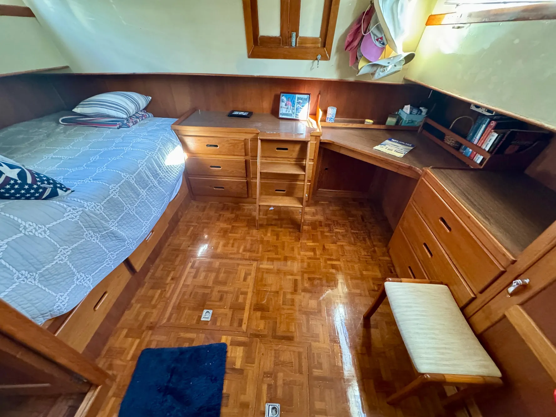 1979 Grand Banks Classic cabin interior with wooden furniture and cozy bed.