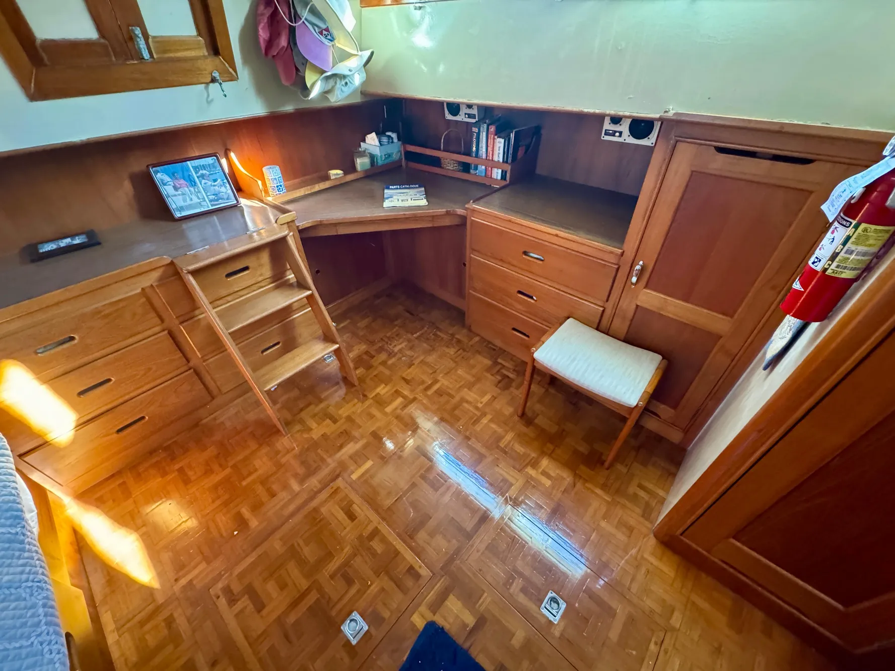 1979 Grand Banks Classic yacht interior with wooden desk and storage cabinets.
