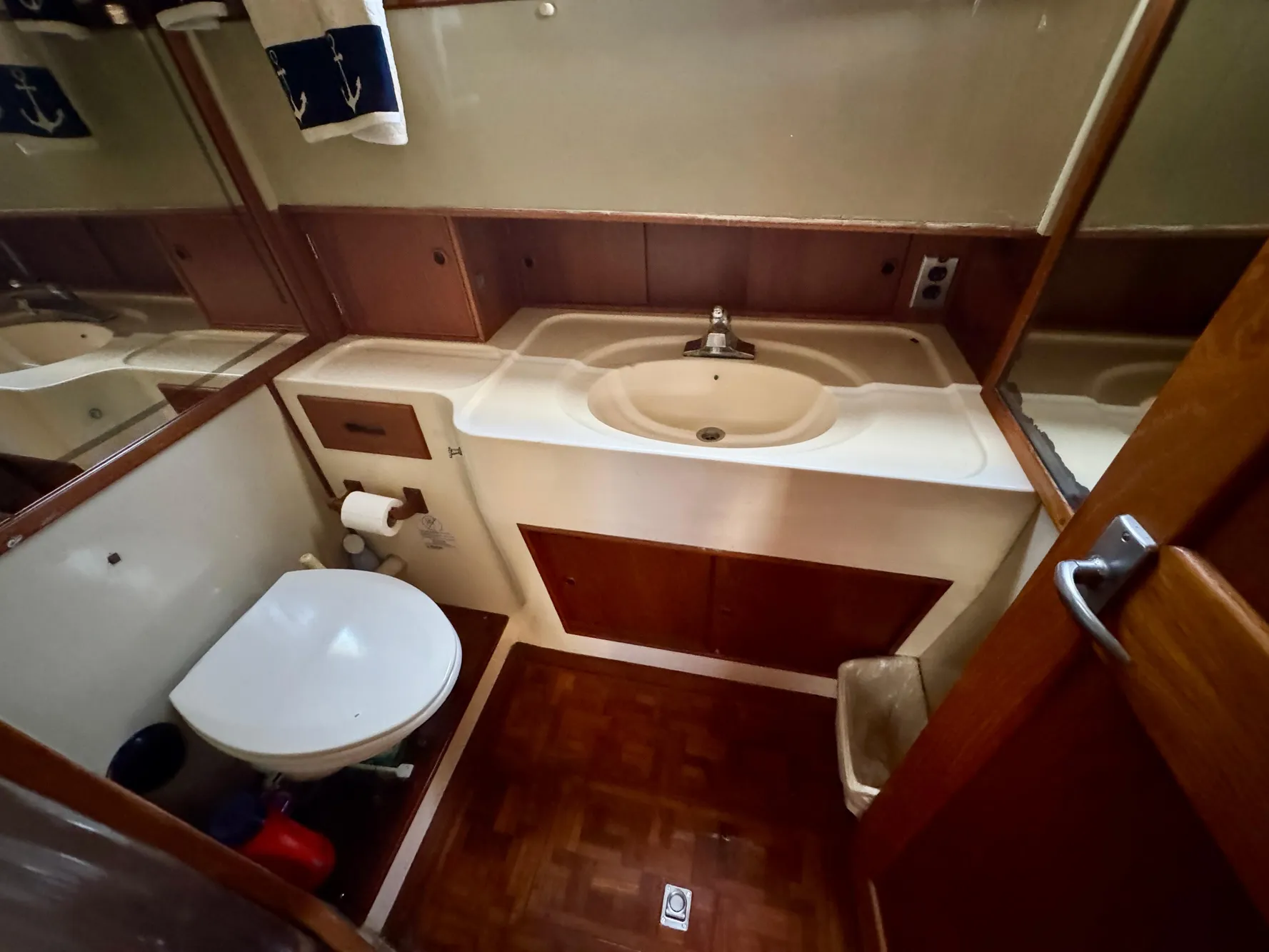 1979 Grand Banks Classic yacht bathroom with sink, toilet, and wood accents.