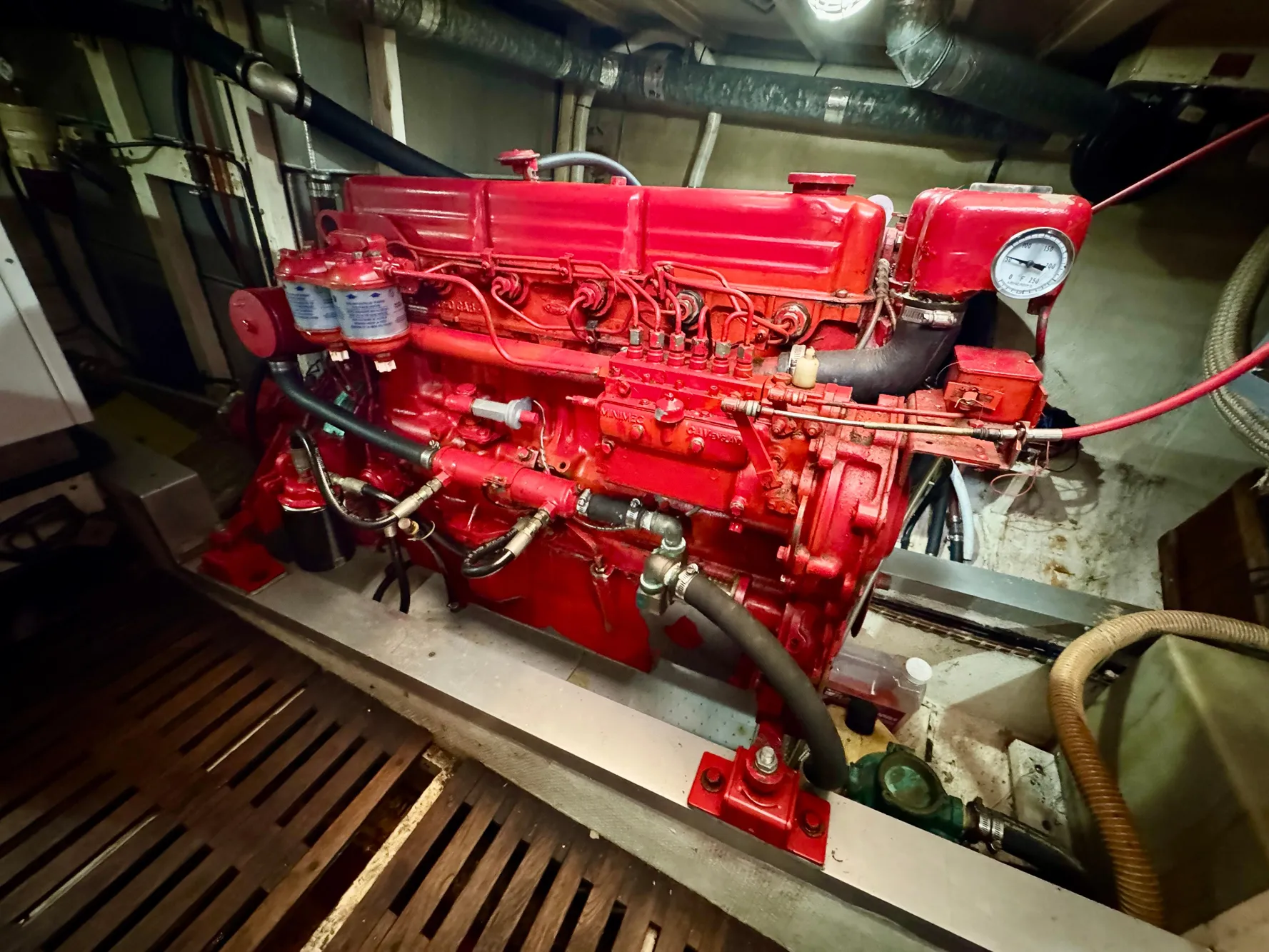 Red engine in a 1979 Grand Banks Classic boat, detailed view.