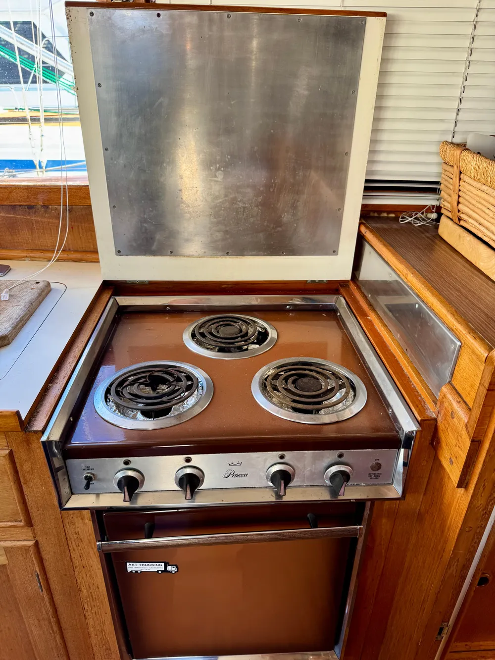 Vintage 1979 Grand Banks Classic stove with three burners in a wooden kitchen setting.