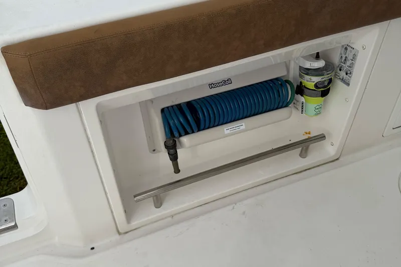 Caymas 341 Center Console Yacht Photos Pics Storage compartment on 2020 Caymas 341 CC boat with hose and cleaning supplies.