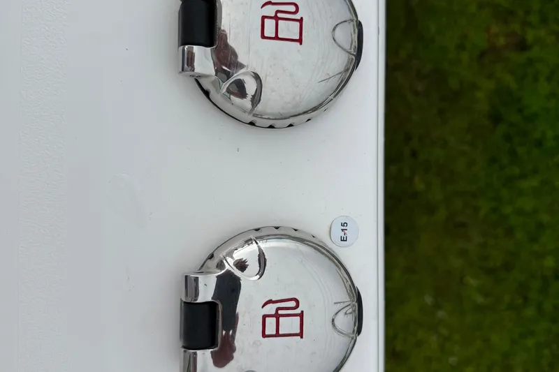 Caymas 341 Center Console Yacht Photos Pics Fuel caps on a 2020 Caymas 341 CC boat, labeled with fuel symbols.