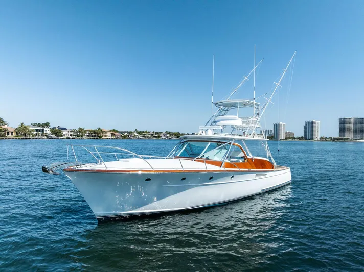 Rebel Yacht Photos Pics Rybovich Sportfish 2000 yacht on calm water with clear blue sky background.