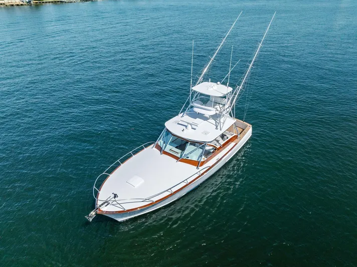 Rebel Yacht Photos Pics Rybovich Sportfish 2000 boat on calm blue water, aerial view.
