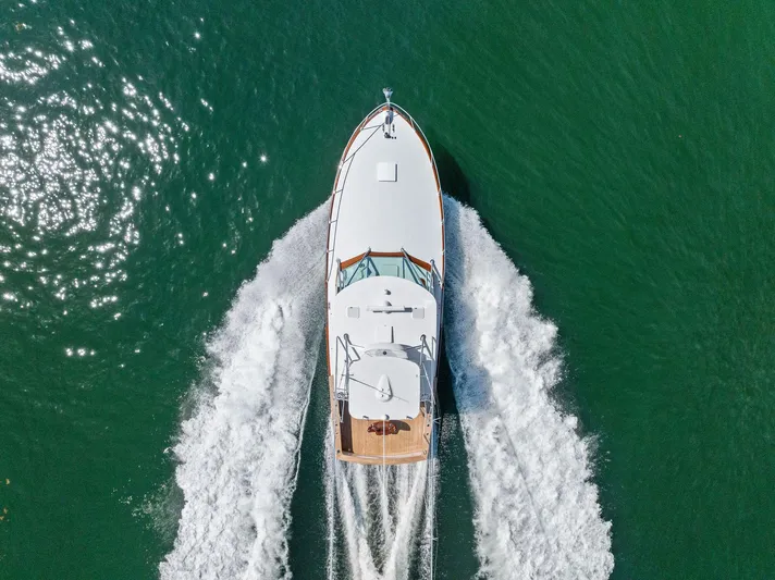 Rebel Yacht Photos Pics Aerial view of 2000 Rybovich Sportfish yacht cruising on green water.
