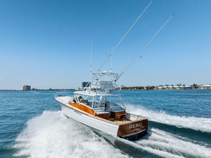 Rebel Yacht Photos Pics Rybovich Sportfish 2000 cruising on open water, showcasing sleek design and powerful performance.