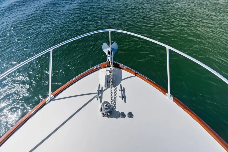 Rebel Yacht Photos Pics Bow of 2000 Rybovich Sportfish boat with anchor over clear water.