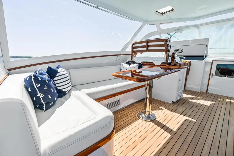Rebel Yacht Photos Pics Luxurious 2000 Rybovich Sportfish yacht interior with wooden deck and cushioned seating.