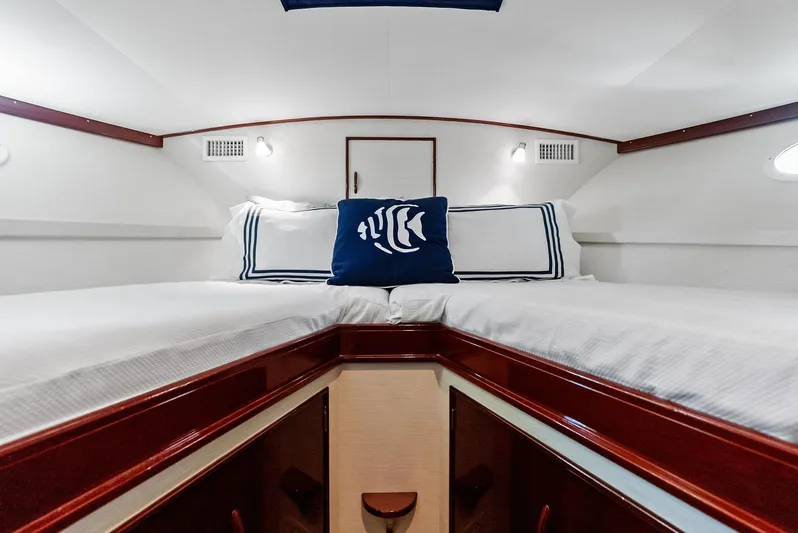 Rebel Yacht Photos Pics Interior cabin of 2000 Rybovich Sportfish boat with twin beds and nautical decor.