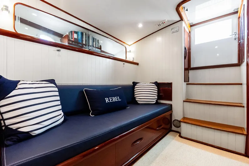 Rebel Yacht Photos Pics Luxurious interior of 2000 Rybovich Sportfish yacht with elegant seating and wooden accents.