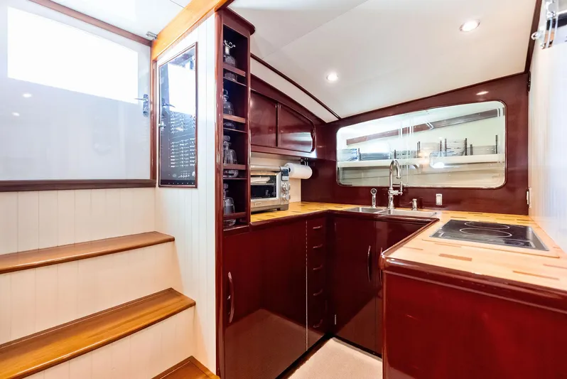 Rebel Yacht Photos Pics Luxurious 2000 Rybovich Sportfish yacht interior with modern kitchen and wooden cabinetry.